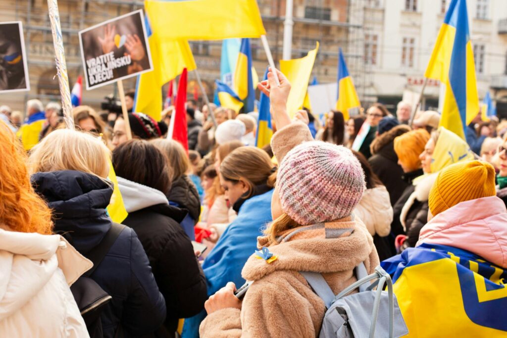 A peaceful protest in Zagreb with Ukrainian flags and diverse participants advocating for peace.